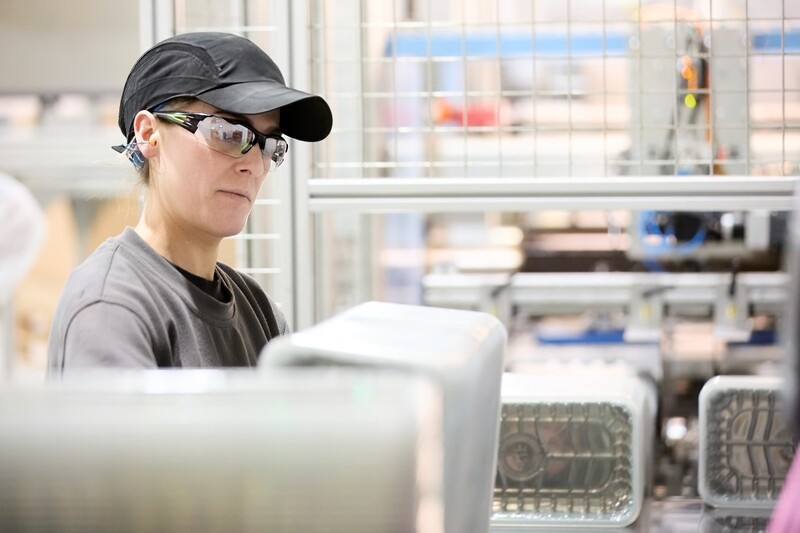 Two men inspecting plastic packaging production