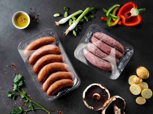 Picture showing two plastic packaging trays with meat covered by flexible films made by kp
