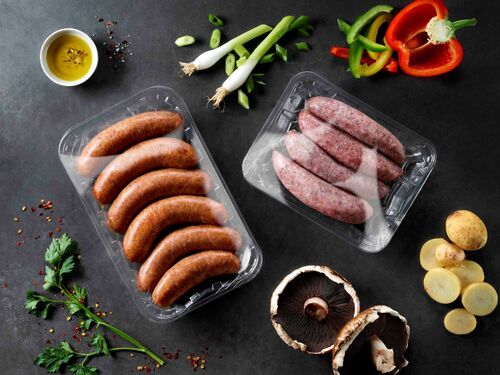 Picture showing transparent PET food packaging trays with meat included flexbile lidding films on top