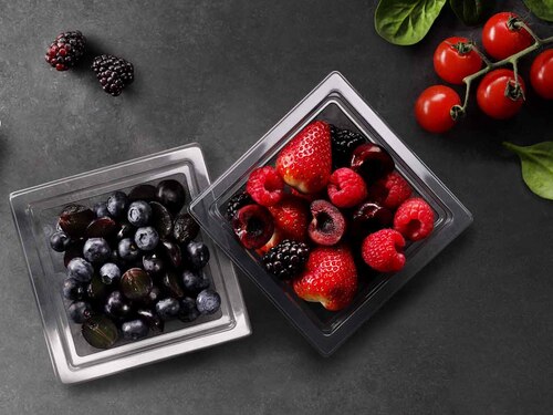 A transparent food packaging tray with various things