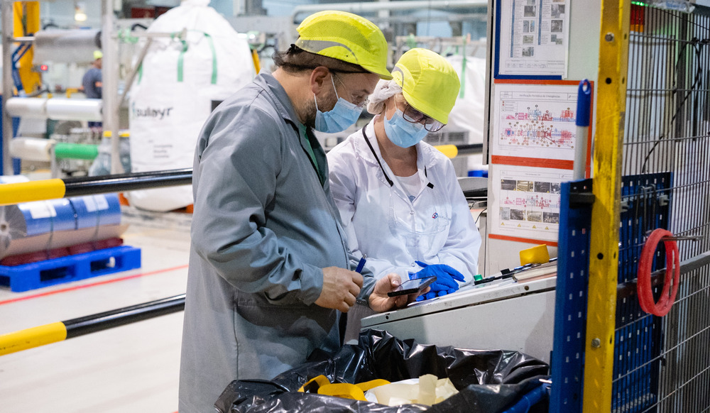A woman and a man looking at safety procedures in the factory