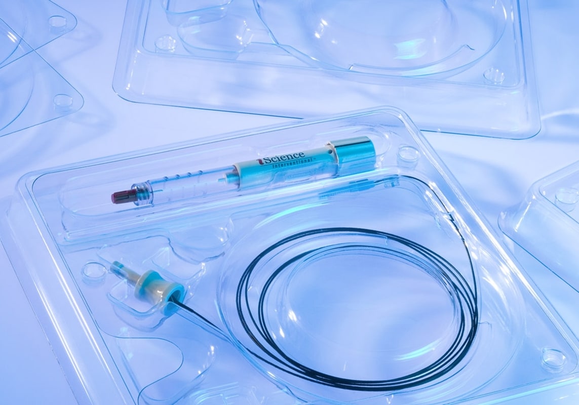 Clear medical device tray packaging showcasing syringe and catheter components for safe storage and transport.