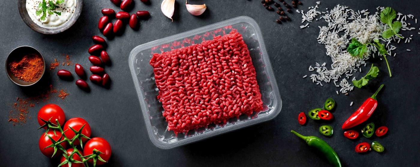 The picture is showing a transparent PET food packaging tray with minced meat inside