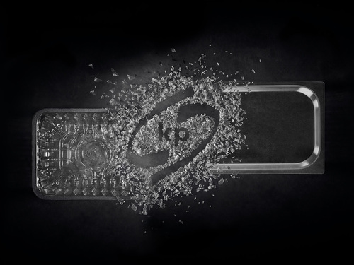 Picture shows a transparent food packaging tray with the kp logo inside on a black background