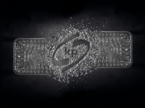Picture shows a transparent food packaging tray with the kp logo inside on a black background