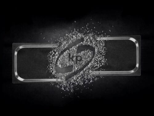 Picture shows a transparent food packaging rigid film with the kp logo inside on a black background