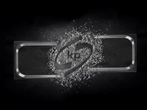Picture showing a transparent plastic food rigid film with kp logo in the middle created out of plastic flakes