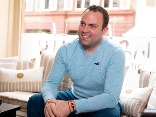 The picture showing Vincent Gass sitting in a comfortable position in a hotel 