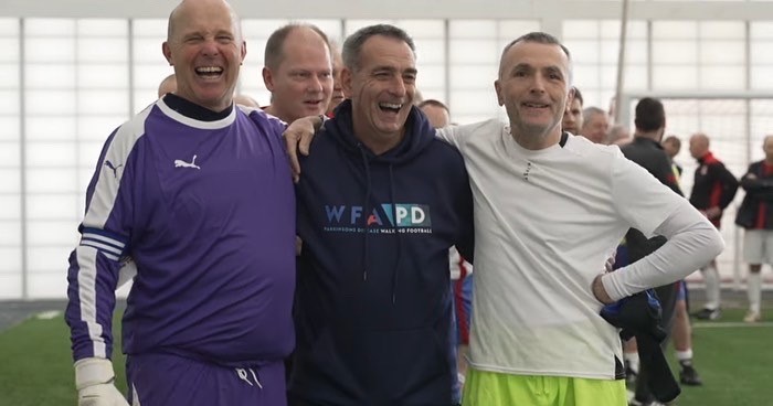 a team posing on a walking football tournament