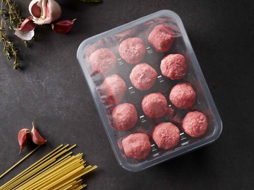 the picture shows a transparent food packaging tray with meatballs inside