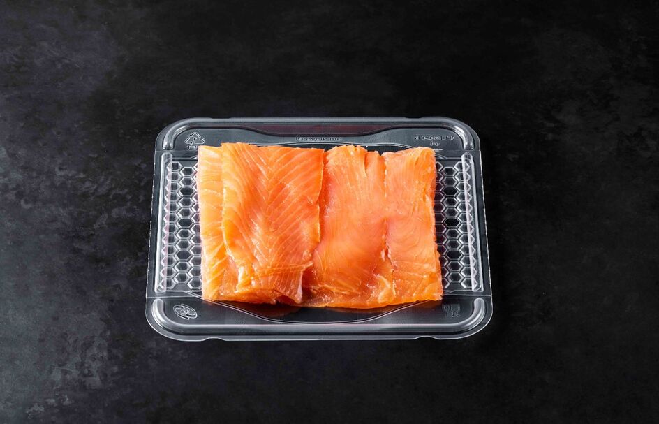 fresh salmon fillet in transparent thermoformed plastic tray packaging