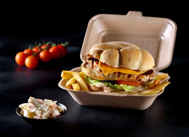 kp Infinity Hotpac filled with a burger and fries on a black background